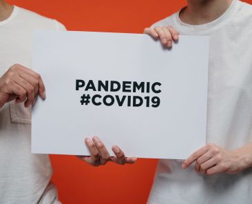 people-holding-white-paper-with-pandemic-covid19-text-3952234